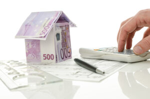 house made of money on blueprints with calculator 2026 03 18 21 55 14 utc